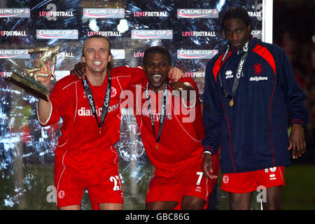 Soccer - Carling Cup - Final - Middlesbrough v Bolton Wanderers. L-R: Middlesbrough's Boudewijn Zenden, George Boateng and Joseph-Desire Job dance on the podium as they celebrate winning the Carling cup Stock Photo