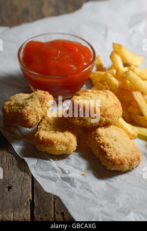 fried chicken with fries on a wooden table Stock Photo