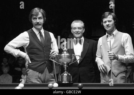 At the finals of the World Snooker Championship, posing with the trophy are Canadian champion Cliff Thorburn (left) and Alex Higgins (right) flanking referee John Street. Stock Photo