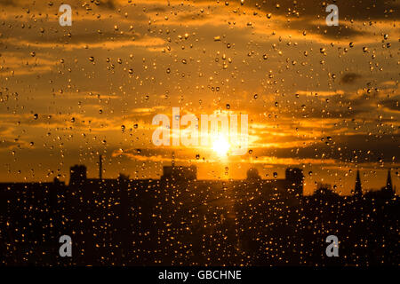 rain drops on  window , sunset sky background Stock Photo