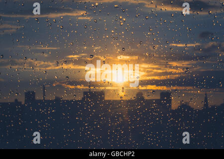 rain drops on  window , sunset sky background Stock Photo