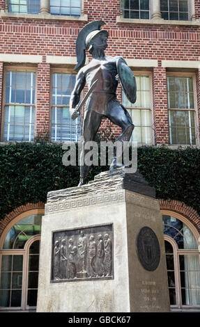 'Tommy Trojan' is a well-known bronze sculpture by Roger Noble Burnham of the unofficial collegiate mascot of the University of Southern California (USC) in Los Angeles, California, USA. Holding a shield and drawn sword, the muscular figure was unveiled in 1930 as a symbol of the school's fighting spirit. On one side of the statue's base is a large bronze plaque by Burnham depicting Helen of Troy. Another side displays the university seal and five words describing the ideal Trojan: Faithful, Scholarly,Skillful, Courageous and Ambitious.The Trojan statue is a popular meeting place for students. Stock Photo