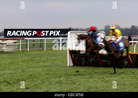 Horse Racing - Kempton Park - Racing Post Chase Day. Blurred action of Rodi Greene on Ken Scott (l) and Robert Thornton on Almnadia Stock Photo