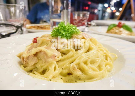 Spaghetti Carbonara - Italian food in a pizzeria Stock Photo