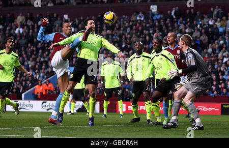 Aston Villa's John Carew is challenged by Wigan Athletic's Paul Scharmer during the Barclays Premier League match at Villa Park, Birmingham. Stock Photo