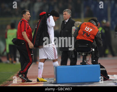 AC Milan's Ronaldinho shows his dejection after he is taken off by Coach Carlos Ancelotti (2nd right) during 2.2 drawn match against Roma in Italian League Serie A game at the Olympic Stadium, Rome, Sunday 11 January 2009: Photo Nick Potts/PA Stock Photo