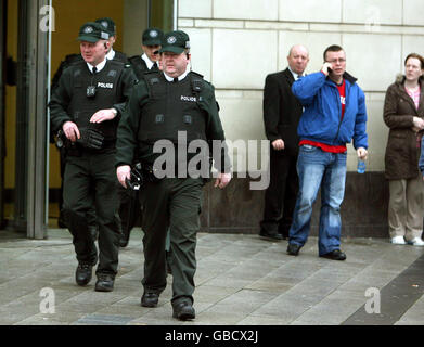 Police officers leave Belfast Laganside court. A man accused of murdering a leading loyalist during a bitter feud in Belfast nearly a decade ago strenuously denied the charge, a court was told today. Stock Photo