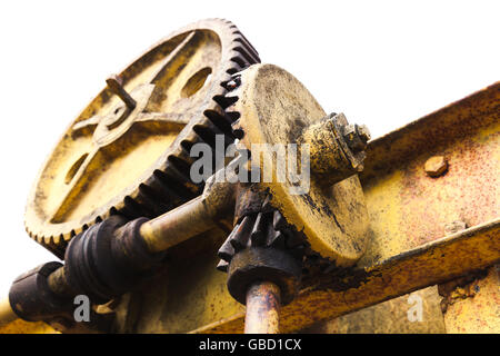 Huge old rusted gears engaged with worm-gear, close up photo isolated on white background with selective focus Stock Photo