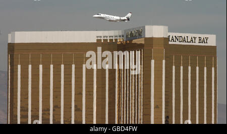 General Stock - American Aviation - Las Vegas Airport. A small plane flies over Mandalay Bay Hotel in Las Vegas as it leaves Las Vegas Airport in USA Stock Photo