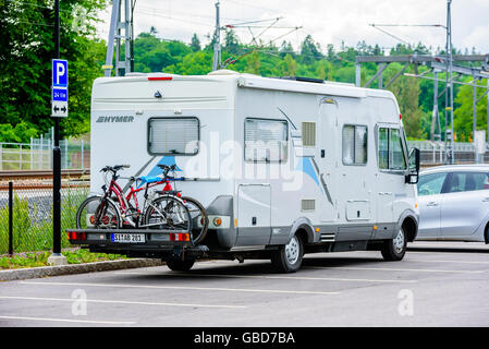 Motala, Sweden -June 21, 2016: Mobile home or camper using up many parking places with an illegal parking. Stock Photo