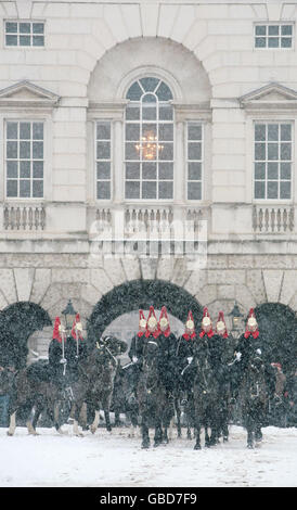 The Blues and Royals Regiment of the Household Cavalry ride back to their barracks in central London after ceremonial Changing of the Guard on Horse Guards Parade. Stock Photo