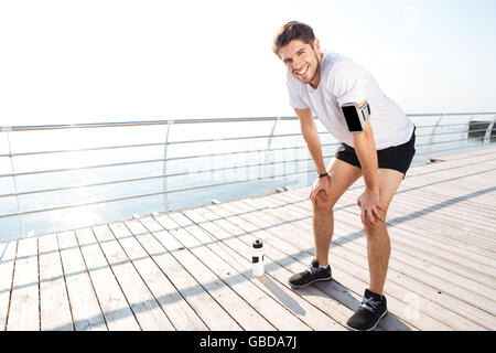 Portrait of a young handsome bearded sportsman resting after workout Stock Photo