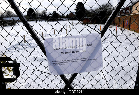 A sign is displayed on the gate of Badshot Lea Village Infant School near Guildford, Surrey, as the school remains closed due to snow. Stock Photo