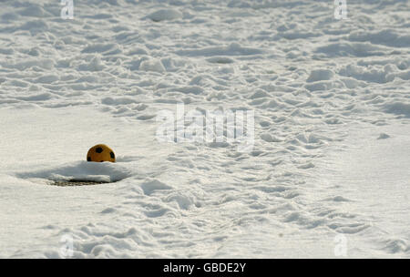 A football is seen in snow as Badshot Lea Village Infant School near Guildford, Surrey, as the school remains closed due to snow. Stock Photo