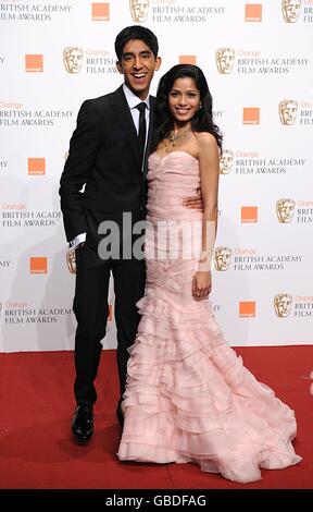 Dev Patel and Freida Pinto (right) wearing a dress by Oscar de la Renta, at the 2009 British Academy Film Awards at the Royal Opera House in Covent Garden, central London. Stock Photo