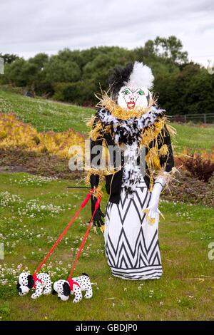 Evil 'Cruella De Vil' stuffed Evil Witch Evil Queen Maleficent. Caricature figure and her Dalmatian dogs at the Wray Scarecrow Festival established 1995, takes place every year, with a different theme. Stock Photo