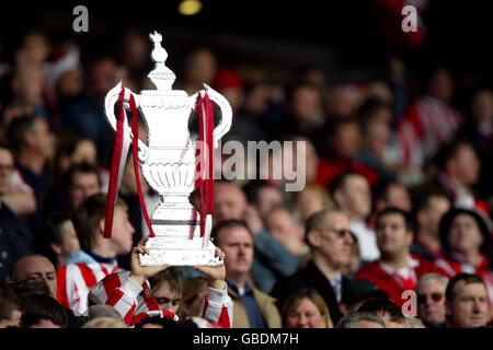 Soccer - AXA FA Cup - Semi Final - Sunderland v Millwall. A Sunderland fan holds aloft an imitation FA Cup Stock Photo