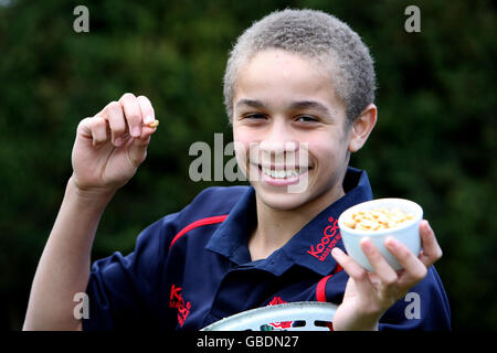 Carl Morris, 13, from Impington, Cambridgeshire, smiles as he holds a peanut, after successfully taking part in a medical trial that has cured him of his nut allergy. Stock Photo