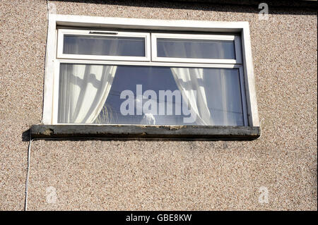 A Police forensics officer is seen through the window of a house on Commercial Street in Ystrad Mynach, Caerphilly, Wales, where a three-and-a-half-month-old baby boy was mauled to death by two family owned dogs around midnight last night.