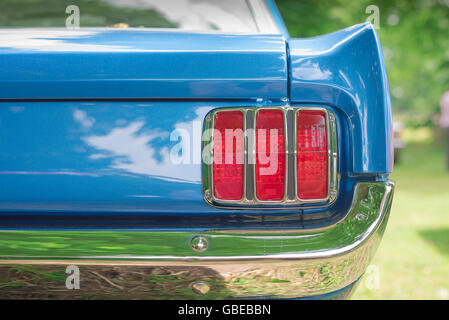 Detail of the rear wing and and tail light cluster of a 1965 Ford Mustang Coupe car. Stock Photo
