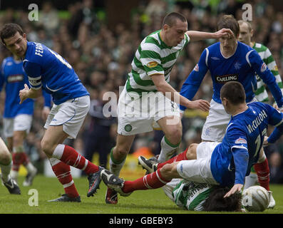 Rangers's Lee McCulloch (right) lands on Celtic's Shunsuke Nakamura (floor, beneath) during the Clydesdale Bank Scottish Premier League match at Celtic Park, Glasgow. Stock Photo