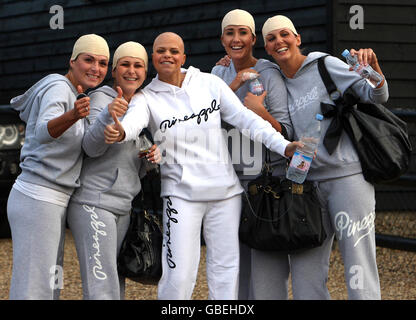 Reality television star Jade Goody poses with friends wearing joke skull caps outside her Essex home on the day before her wedding to fiance Jack Tweed. Stock Photo