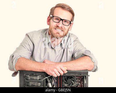 Master of computer repair isolated on white. Computer repair concept. Stock Photo