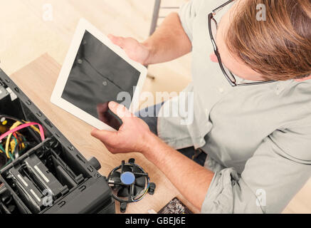 Man using tablet pc during the computer repair. Stock Photo
