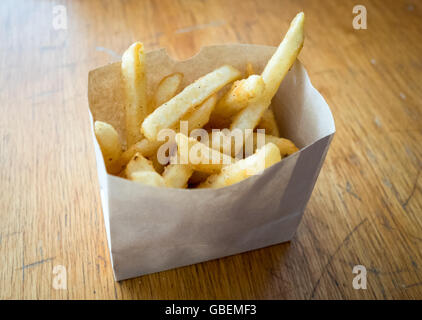 French fries in a paper carton. Stock Photo