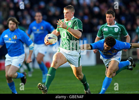Ireland's Jamie Heaslip escapes the tackle of Italy's Andrea Masi during the RBS 6 Nations match at the Stadio Flamino, Rome, Italy. Stock Photo