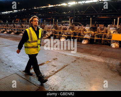 A worker walks past a furnace at Corus Steel plant, Corby, Northamptonshire. Stock Photo