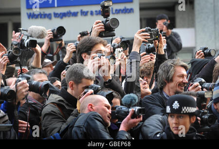 Photographers outside New Scotland Yard in London today hold a mass photo shoot in protest at a new anti-terror law. Photojournalists say Section 76 of the Counter Terrorism Act, which became law today, could see them arrested for doing their job. Stock Photo