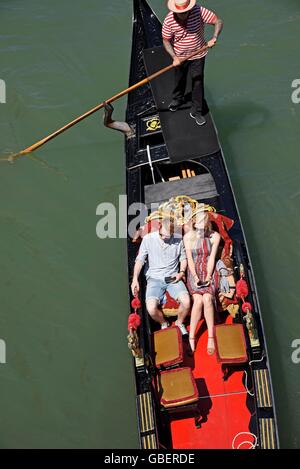 tourists, gondolier, gondola, canal, Venice, Venezia, Veneto, Italy Stock Photo