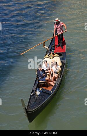 tourists, gondolier, gondola, canal, Venice, Venezia, Veneto, Italy Stock Photo