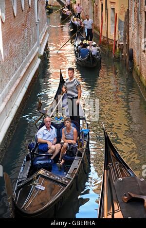 tourists, gondolier, gondola, gondolas, canal, Venice, Venezia, Veneto, Italy Stock Photo