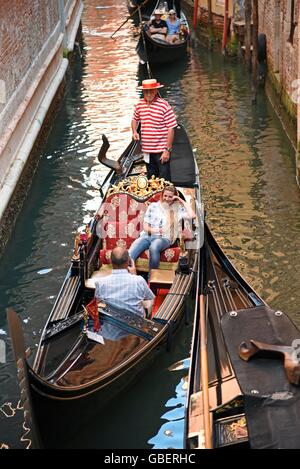 tourists, gondolier, gondola, gondolas, canal, Venice, Venezia, Veneto, Italy Stock Photo