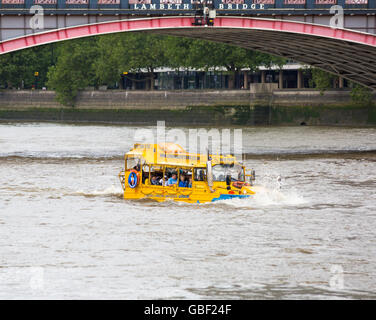 London Duck Tours amphibious vehicle boat going along River Thames under Lambeth Bridge, London in July Stock Photo