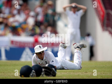 England captain Andrew Strauss lies on the ground after misfielding during the fourth test at Kensington Oval, Bridgetown, Barbados. Stock Photo