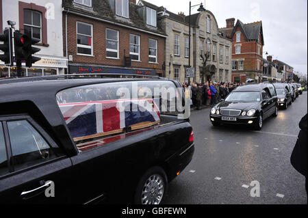 A Union Flag drapes a coffin in a hearse as it makes its way through Wootton Bassett as three soldiers from 1st Battalion The Rifles, are repatriated after being killed in Afghanistan. Stock Photo