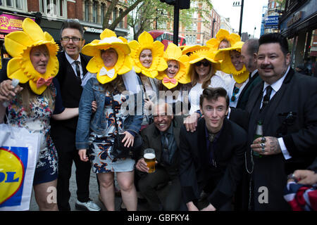 Hen party friends with daffodil constumes have their photo taken with a group of Teddy Boys in London, United Kingdom. A bachelorette party, hen party, hen night or hen do, is a party held for a woman who is about to get married. The terms hen party, hen do or hen night are common in the UK. Stock Photo