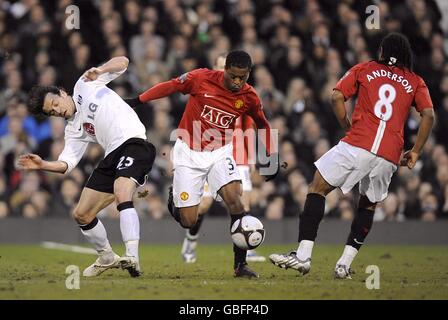 Fulham's Simon Davies (left) in action against Manchester United's Patrice Evra (centre) and Oliviera Anderson (right) Stock Photo