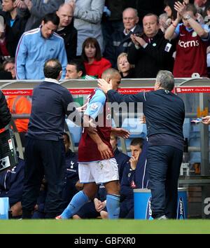Aston Villa's Gabriel Agbonlahor (centre) is congratulated on his performance by manager Martin O'Neill (left) and assistant manager John Robertson (right) as he is substituted Stock Photo