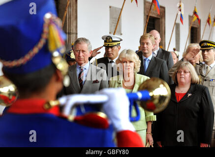 The Prince of Wales and The Duchess of Cornwall with Britain's Ambassador to Ecuador Linda Cross (right), stand to attention as the national anthem of Ecuador is played, at the Presidential Palacein Quito.