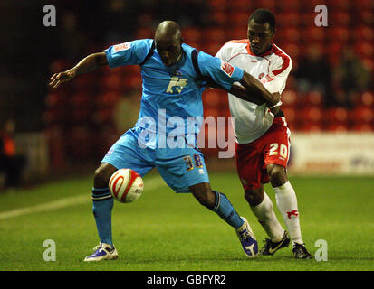 Brighton & Hove Albion's Lloyd Owusu (left) shields the ball from Walsall's Manny Smith during the Coca-Cola League One match at the Banks Stadium, Walsall. Stock Photo