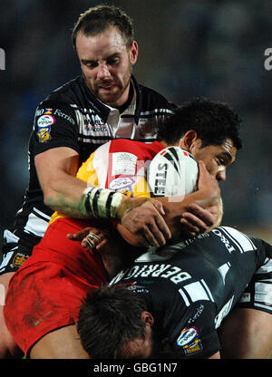 Hull FC's Shaun Berrigan (below) and Ewan Dowes combine to tackle Catalans Dragons' Dimitri Pelo (centre) during the engage Super League match at the KC Stadium, Hull. Stock Photo