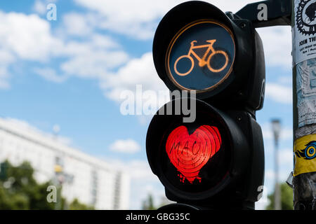 Detail of red stop light at  traffic lights for cyclists with red love heart in Berlin Germany