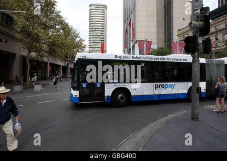 A bendy bus makes its way along Alfred Street near to Circular Quay in Sydney, Australia Stock Photo