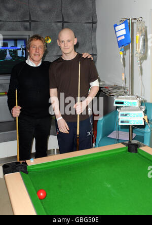 From left to right: Roger Daltrey of the Who plays pool with David Oakley, 19, from Hertfordshire, a cancer patient with spinal cell sarcoma, during a visit to the Teenage Cancer Trust Unit at University College Hospital in central London. Stock Photo