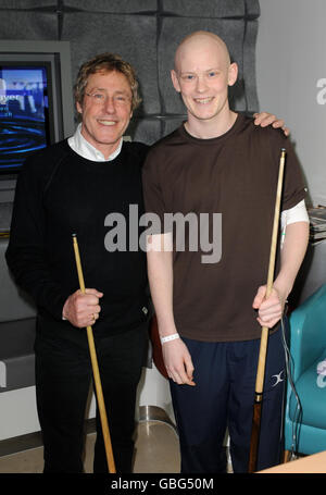 From left to right: Roger Daltrey of the Who plays pool with David Oakley, 19, from Hertfordshire, a cancer patient with spinal cell sarcoma, during a visit to the Teenage Cancer Trust Unit at University College Hospital in central London. Stock Photo