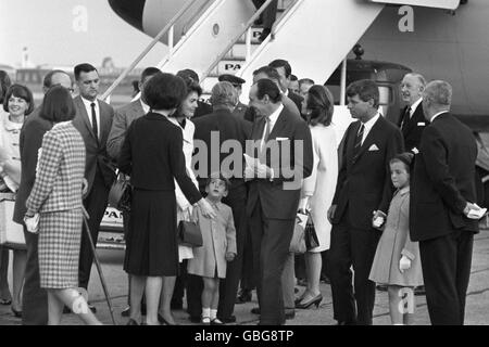 Jacqueline Kennedy surrounded by members of the family on arrival at London Airport by US Presidential Boeing 707. She is holding the hand of her son, John Kennedy. At the right, Senator Robert Kennedy holds the hand of Jacqueline's daughter Caroline. Background, (white coat) is Lee Radziwill, sister of Mrs Kennedy. Jackie and members of the family have flown in for the unveiling by Queen Elizabeth II of the Runnymede British Memorial to assassinated US President John F Kennedy. Stock Photo